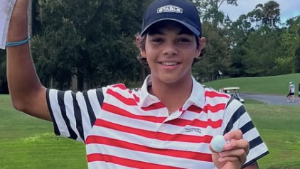Charlie Woods celebrates his ace at Sawgrass