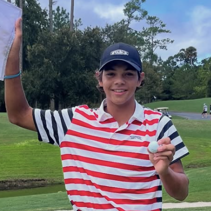 Charlie Woods celebrates his ace at Sawgrass