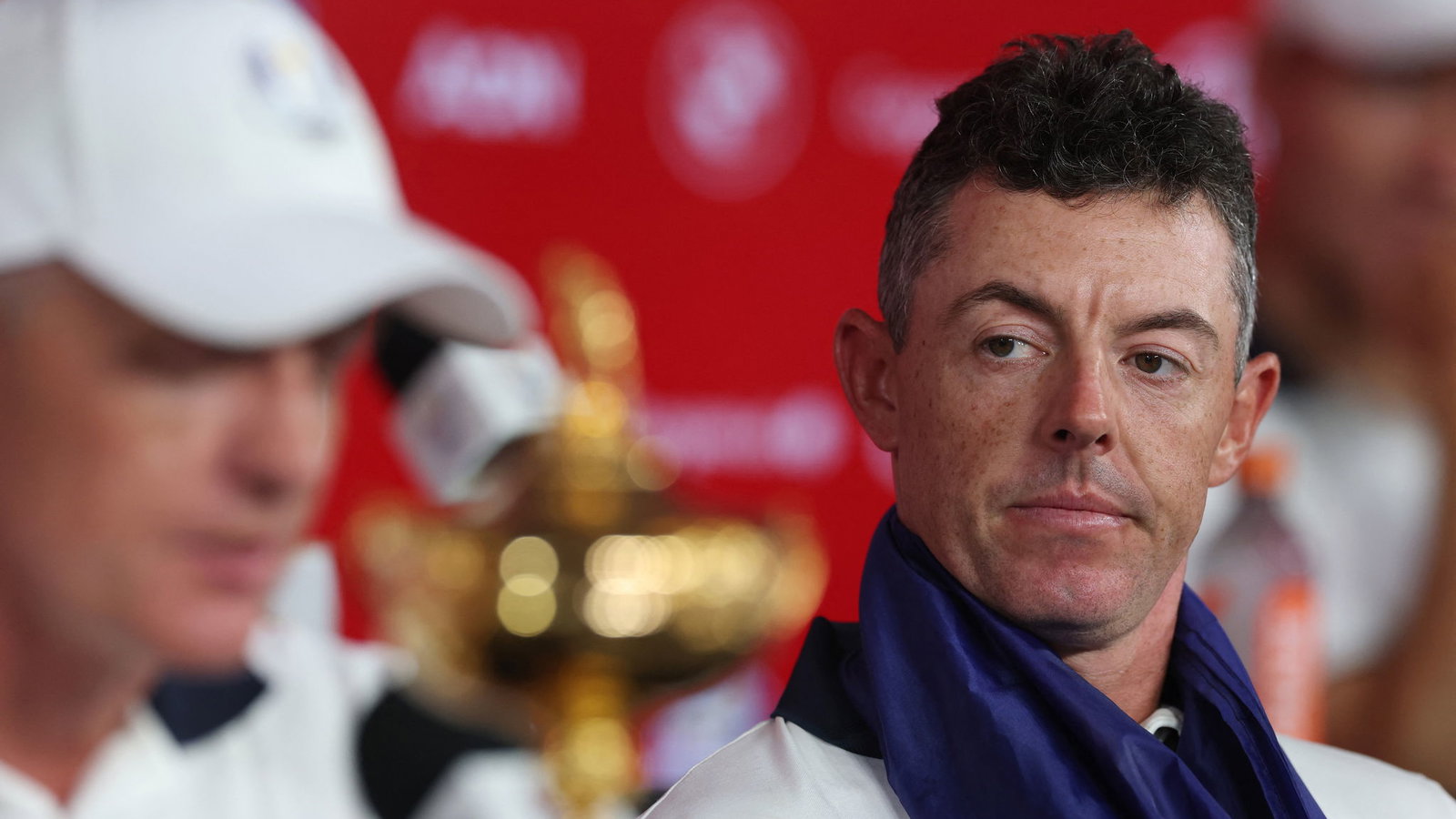 Rory McIlroy listens to Luke Donald