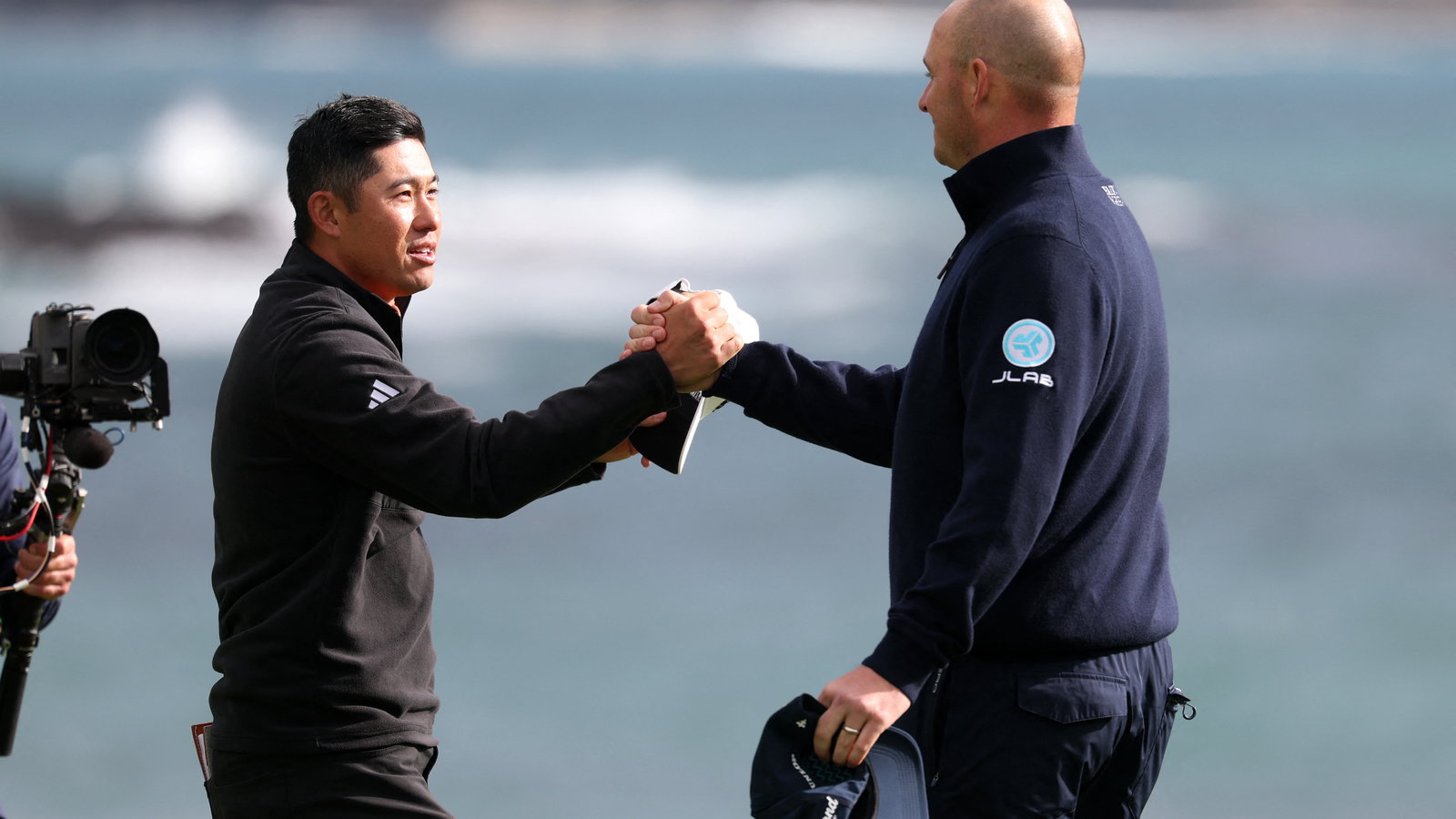 Morikawa and Straka on the 18th green