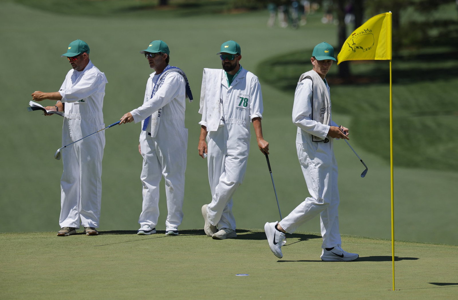 Caddies prepare during Masters practice