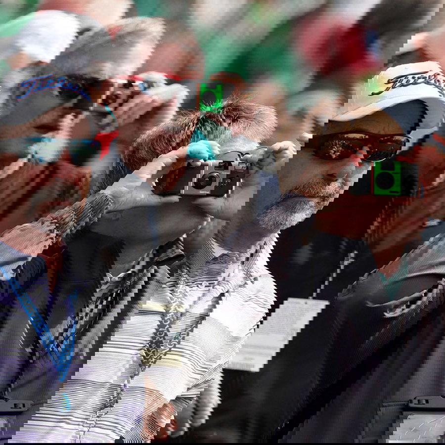 Patrons take photos with permitted cameras on Tuesday at Augusta National. Image: Reuters