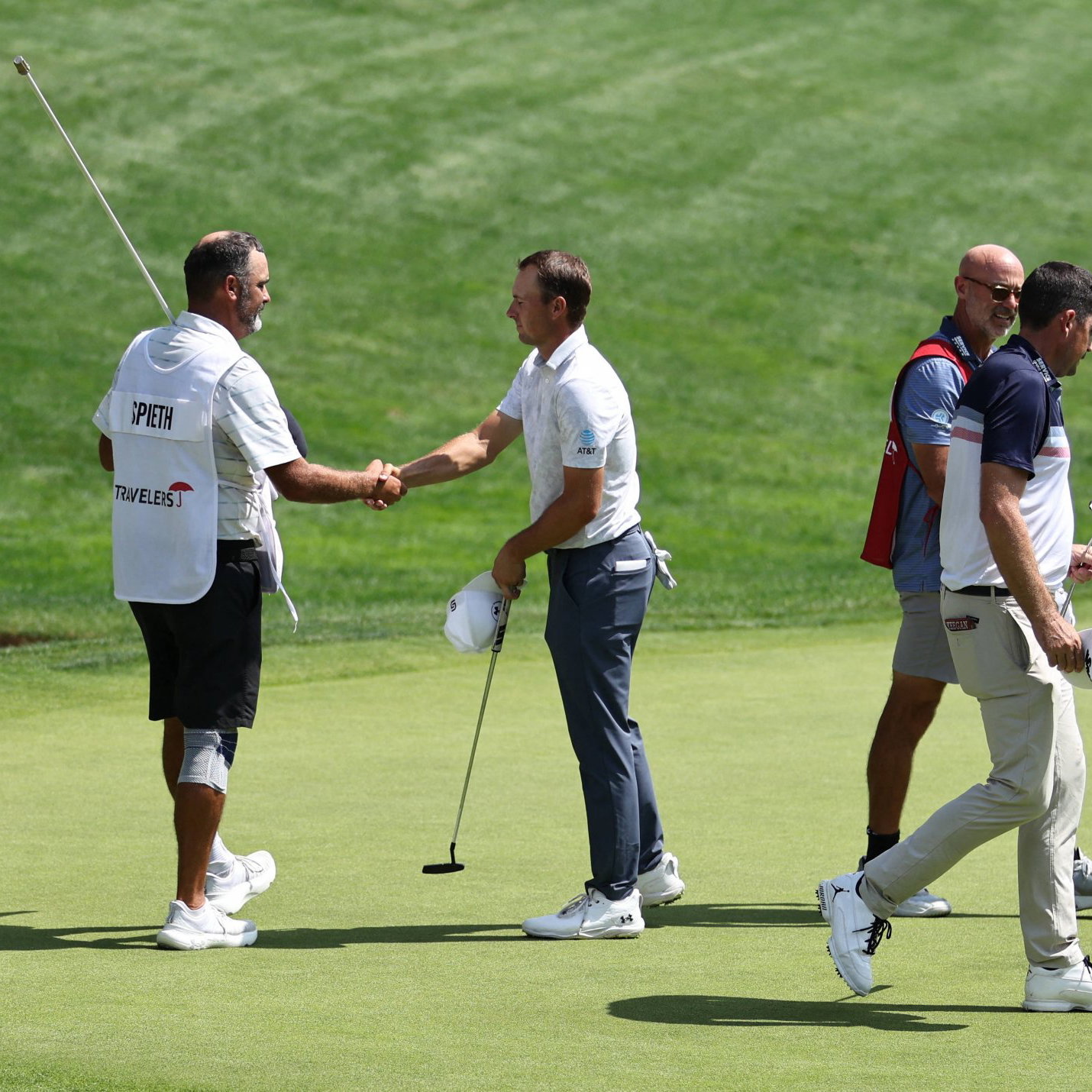 Jordan Spieth shakes hands with his caddie Michael Greller