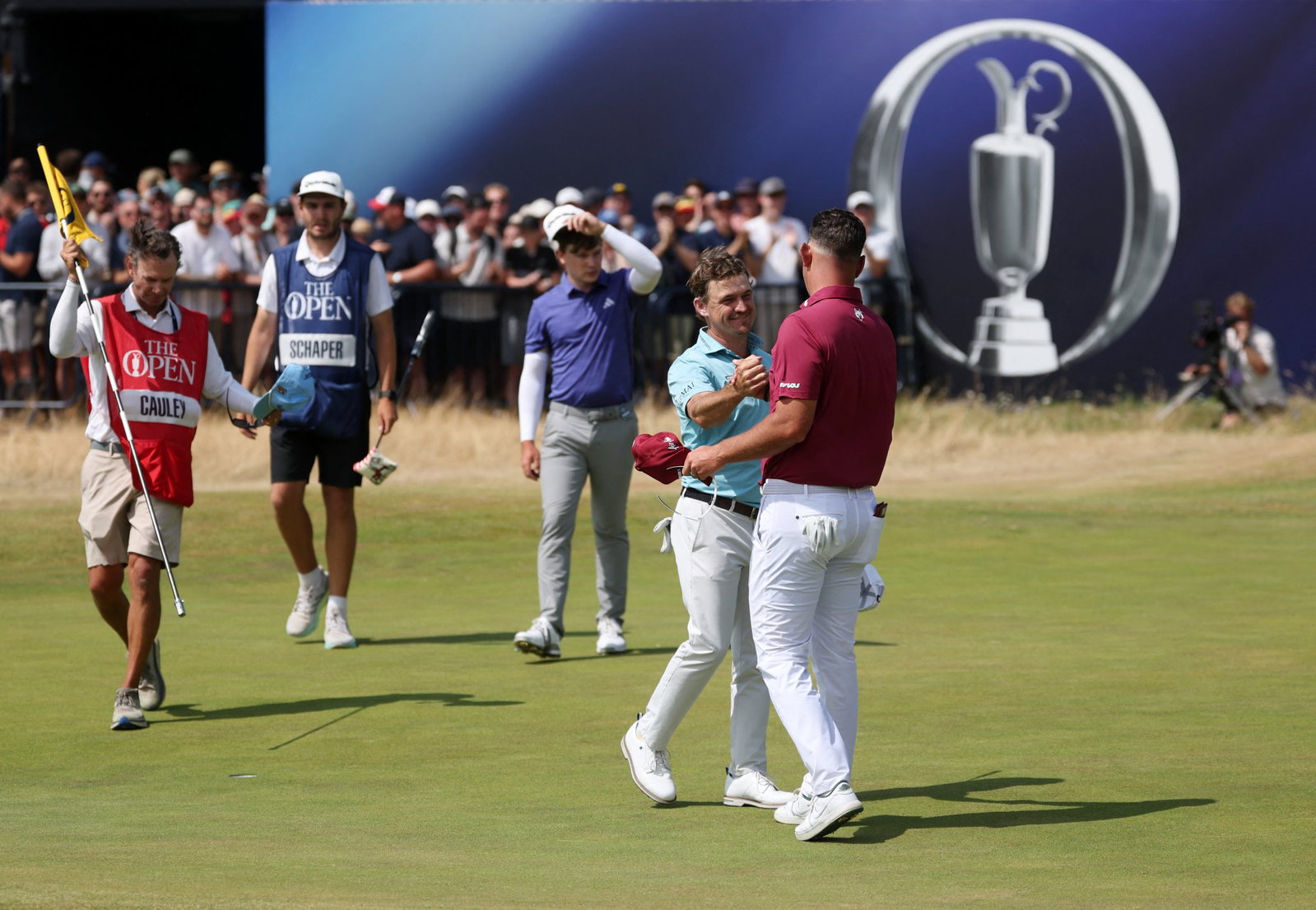 Lucas Herbert shakes hands with playing partner Bud Cauley