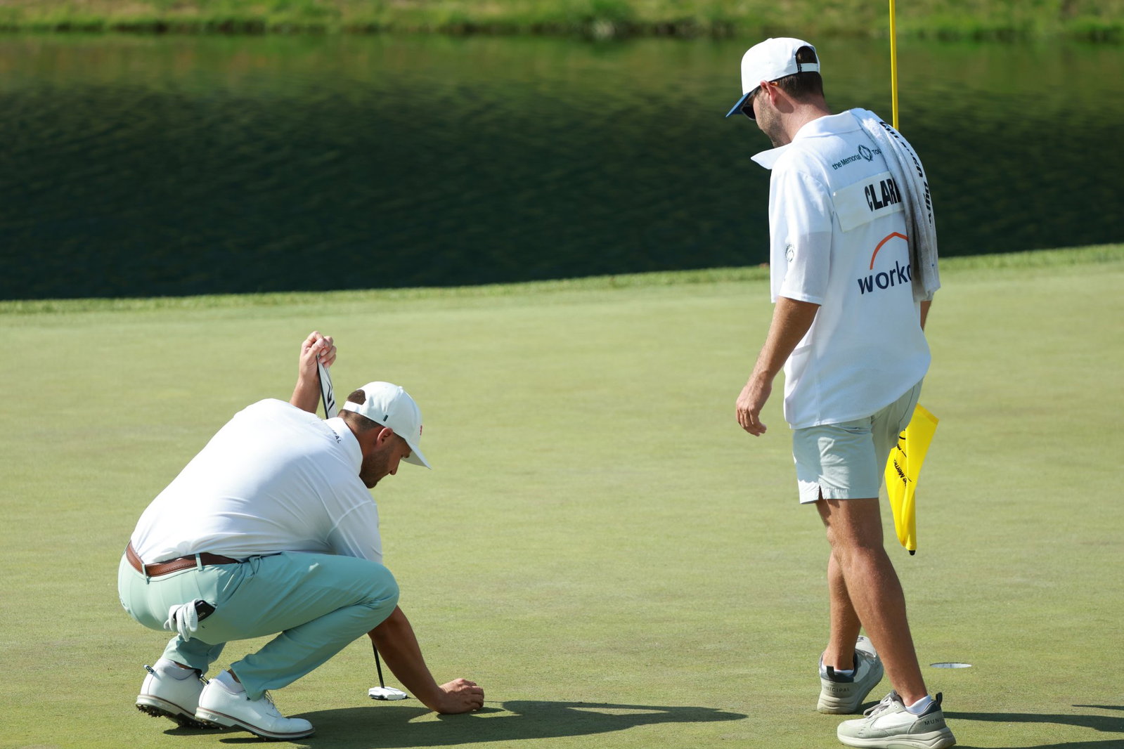 Clark and his caddie lining up a putt at Muirfield Village