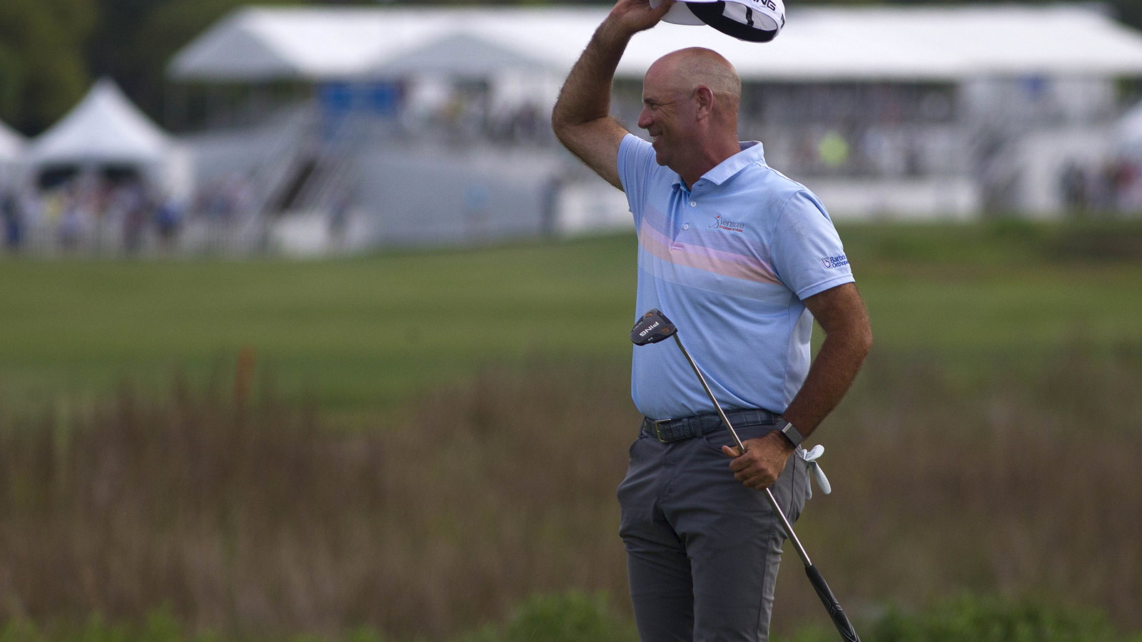 Stewart Cink throws his golf ball in celebration and hits spectator on the head