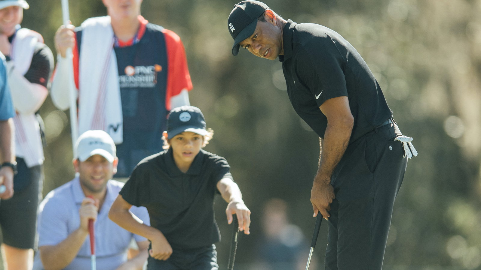 EXHAUSTED Tiger Woods watches son Charlie on driving range after Pro-Am round