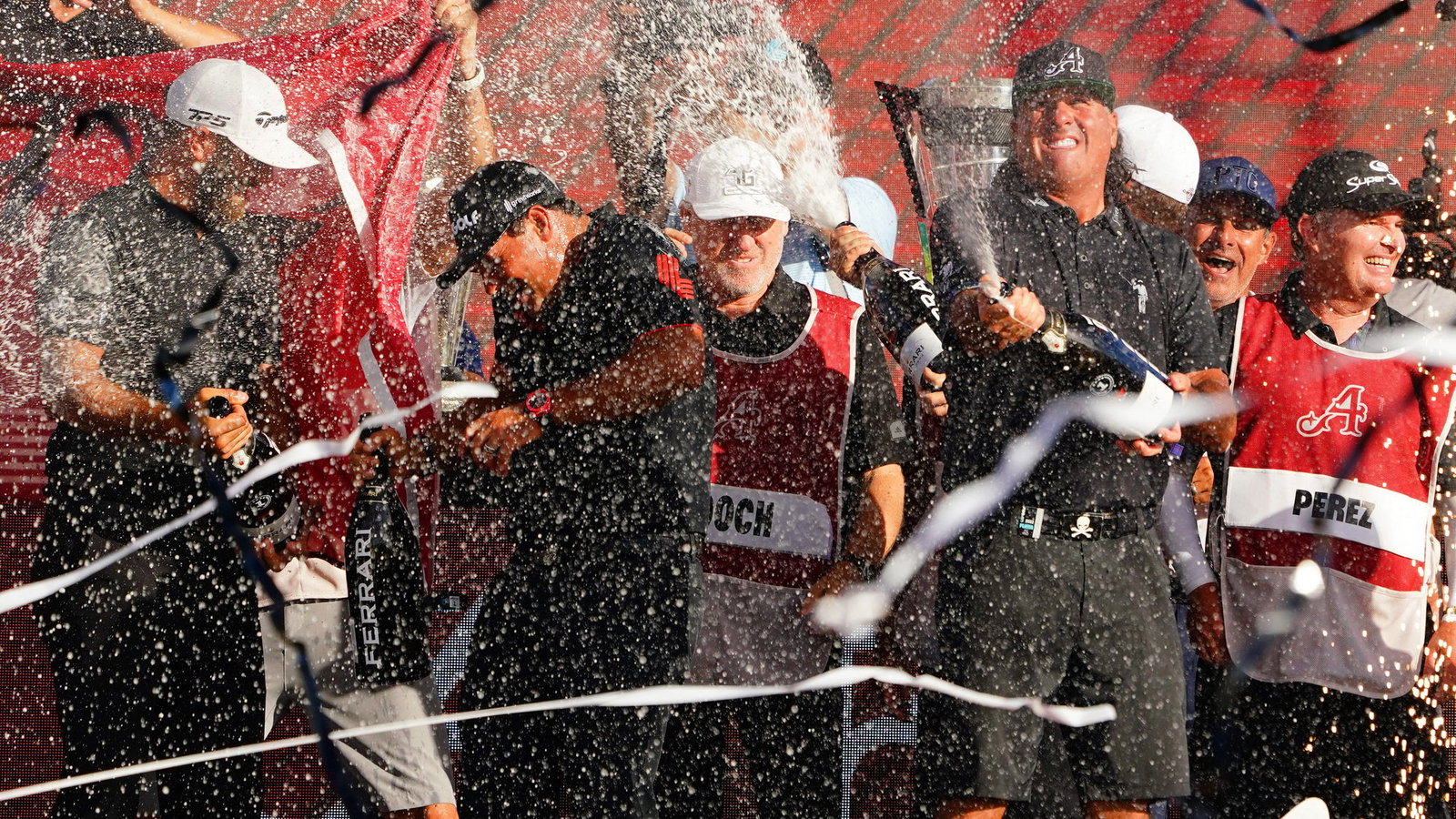 LIV Golf team champion Pat Perez receives congratulations from PGA Tour stars