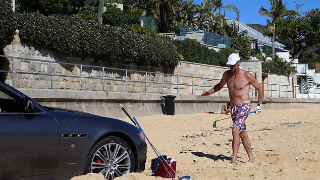 maserati drivers parks on beach to play golf and pump bob marley tunes
