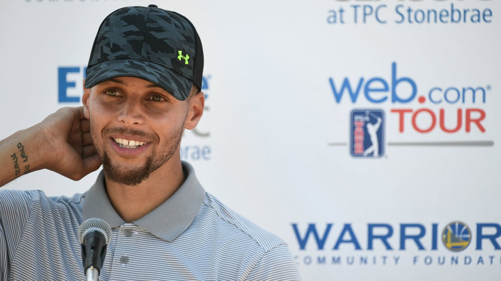 steph curry slam dunks opening tee shot into golf cart cup holder