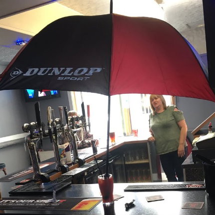 man sticks golf brolly in his sex on the beach cocktail