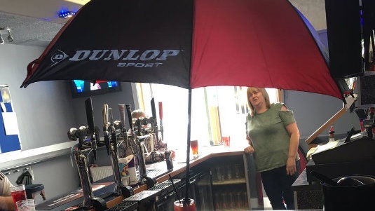 man sticks golf brolly in his sex on the beach cocktail