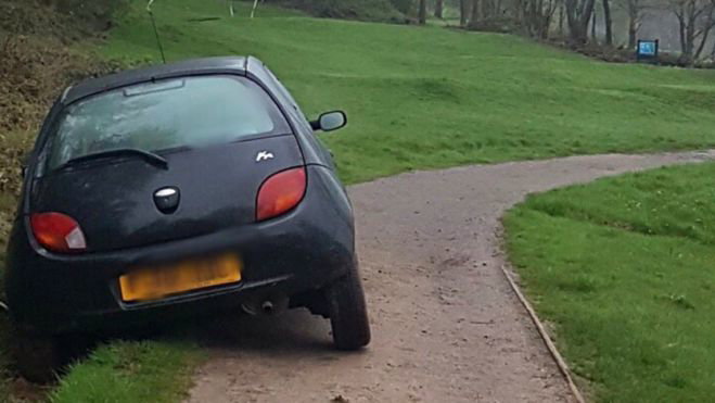 Young lady motorist drives into ditch at 11th hole, in a car!