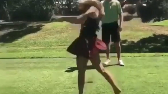 lady golfer hits golf shot then her skirt flies off