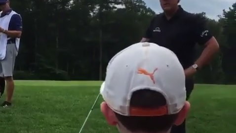 phil mickelson receives golf shot advice from little boy in crowd