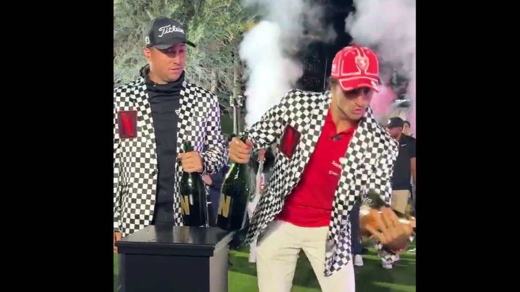 Carlos Sainz breaks the Netflix Cup in celebration with Justin Thomas